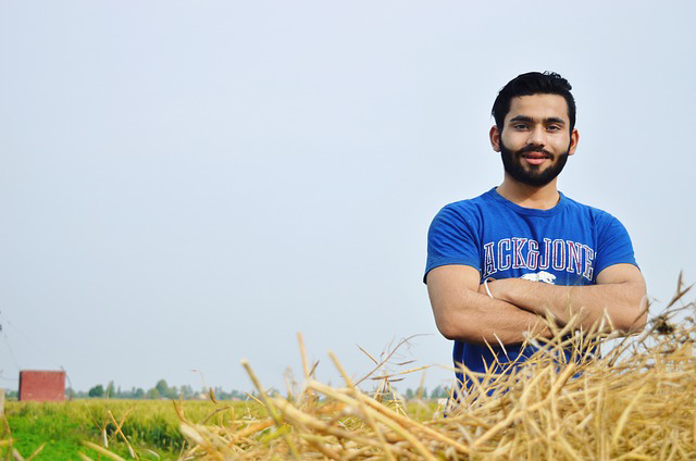 "Young farmworker standing in a  field"