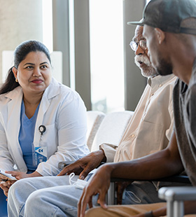 A doctor visits with her patients.