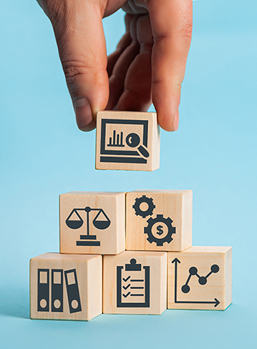 Person's hand, putting compliance wooden blocks into a pyramid