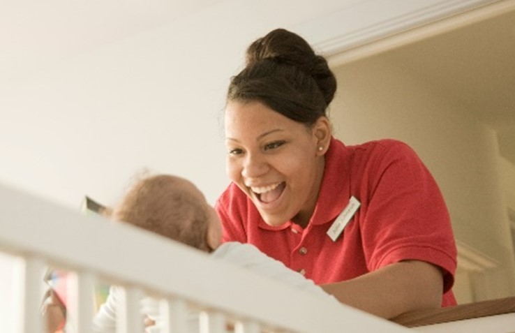 Mother smiling at child. 