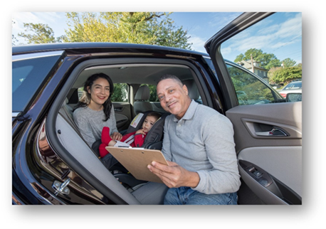 Image of Child Passenger Safety Technician with a Mother and Child at a Safety Seat Checkup Event