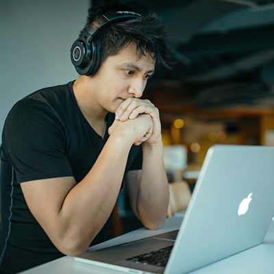 A man looks at a laptop.