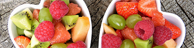 Heart-shaped bowls filled with berries.